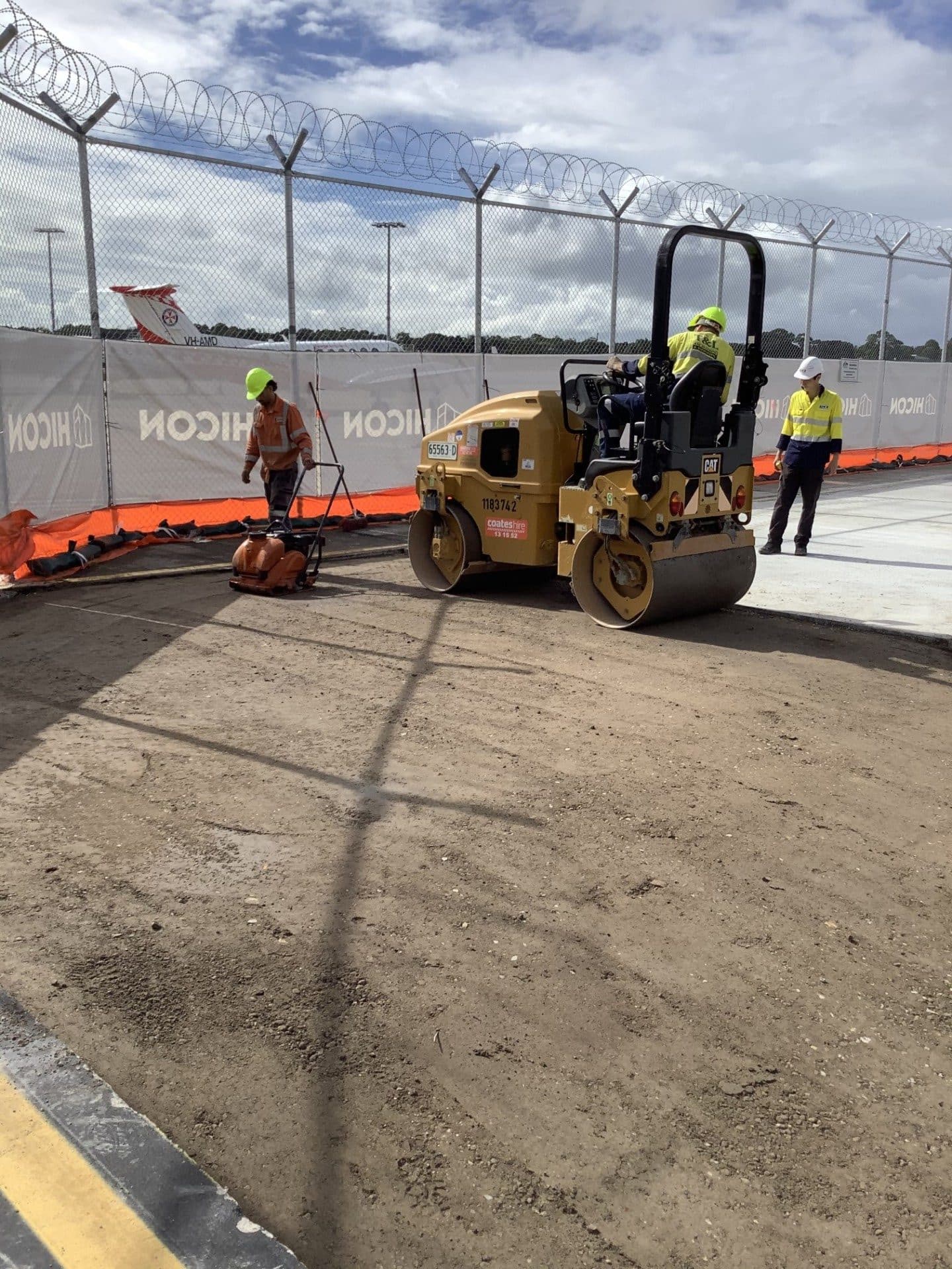 Roller compacting base during minor asphalt works at Sydney Airport